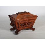 A Victorian mahogany sarcophagus shaped wine cooler, the hinged rectangular top centred with a