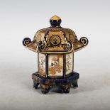 A Japanese Satsuma pottery blue ground pagoda shaped box and cover, Meiji Period, decorated with