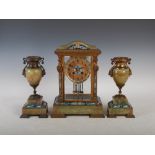 A late 19th century French onyx and champleve enamel clock garniture, the clock with a circular