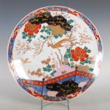 A Japanese Imari charger, late 19th/ early 20th century, decorated with a fenced garden of peony,