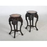 A pair of Chinese dark wood octagonal shaped jardiniere stands, Qing Dynasty, the octagonal tops