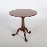 A George III style mahogany snap top occasional table, the hinged circular top resting on a bird