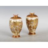 A pair of Japanese Satsuma pottery vases, Meiji Period, decorated with figures in a river