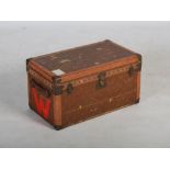 An early 20th century leather and brass bound cabin trunk in the style of Louis Vuitton, with hinged