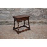 An 18th century oak joynt/ joint stool, the planked rectangular top with a moulded edge above a