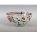 A Japanese Imari bowl, Edo Period, decorated with a central circular shaped panel enclosing a