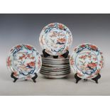 A set of twelve Japanese Imari plates, Edo Period, decorated with pavilions in a river landscape