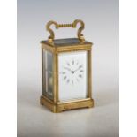 A late 19th century brass striking carriage clock, the white enamel dial with Arabic and Roman