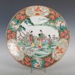 A Japanese charger, late 19th/ early 20th century, decorated with a garden of bijin and pine trees