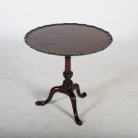 A George III mahogany snap top occasional table, the hinged circular top with a moulded edge,
