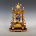 A 19th century ormolu, porcelain and enamel mounted mantle clock, the circular dial set with