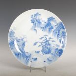 A Japanese porcelain blue and white charger, late 19th/ early 20th century, decorated with figures