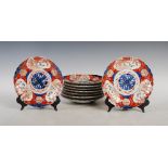 Nine Japanese Imari plates, late 19th/ early 20th century, decorated with central blue mon within