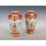 A pair of Japanese Kutani porcelain twin handled vases, late 19th/ early 20th century, decorated