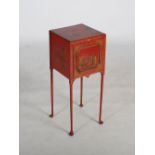 An early 20th century red lacquer chinoiserie decorated bedside cabinet, the rectangular top above a