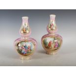 A pair of late 19th century Berlin porcelain pink ground double gourd vases, decorated with circular