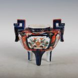 A Japanese Imari koro, late 19th/ early 20th century, decorated with panels of peony and foliage,