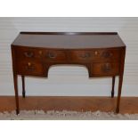 A 19th century mahogany and boxwood lined bow front knee hole dressing table, the shaped rectangular