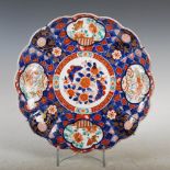 A Japanese Imari dish, late 19th/ early 20th century, decorated with a central roundel of peony