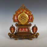 A late 19th century French Etruscan style gilt metal and porcelain mounted mantle clock, the