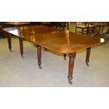 An early 19th century mahogany concertina action extending dining table, the rounded rectangular top