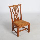A late 19th/ early 20th century oak Gossip chair in the George III style, with drop in leather