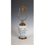 A gilt metal mounted Delft pottery jar converted to a table lamp, decorated in Fazakerley colours