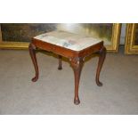 An early 20th century George III style stool, with floral upholstered drop-in seat, raised on four