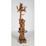 A late 19th century carved and painted wood Black Forest hall stand, carved in two sections with a