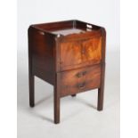 A George III mahogany tray top commode, the rectangular top above a pair of cupboard doors and