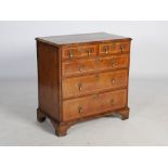 An 18th century walnut chest, the rectangular top with herringbone inlaid border and moulded edge,
