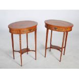 A pair of 19th century painted satin wood side tables, the oval shaped tops decorated with putti