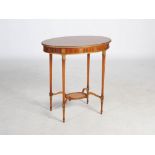 An early 20th century satinwood and parcel gilt oval shaped occasional table, the cross banded top