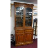 Tall oak bookcase on base