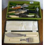 Assortment of cutlery and boxed fish servers