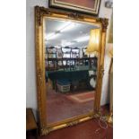 Very large and ornate gilt framed and bevelled glass mirror