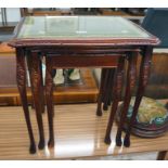 Nest of mahogany and glass top tables