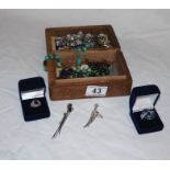 Carved treen box containing costume jewellery and mystic topaz set silver ring