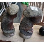 2 stone otter figures