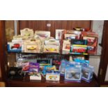 Large collection of Corgi and Matchbox boxed cars and planes (over 2 shelves)