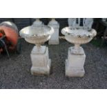 Pair of large stone planters on plinths