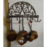 Iron rack with copper saucepans
