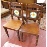 Pair of Edwardian hall chairs with unusual tile backs