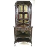 An Edwardian mahogany Chinese Chippendale style corner unit, pierced hood above mirrored back,