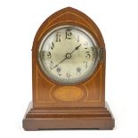 An Edwardian mahogany and line inlaid mantle clock, the silvered dial with scrolling Arabic numerals