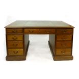 An Edwardian mahogany partners desk, tooled and gilded leather skillet above three frieze drawers to