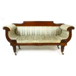 A Victorian mahogany double scroll armed sofa with foliate carving, reeded legs and blue and cream