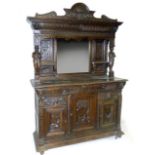 A Victorian oak mirror back sideboard, with central mirror between a carved cornice, flanked by a