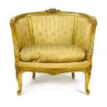 A French gilded tub chair with foliate scrolling and decoration, padded back and arms, loose seat