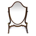 A 19th Century mahogany shield shaped toilet mirror with scrolling supports and turned ivory mounts.